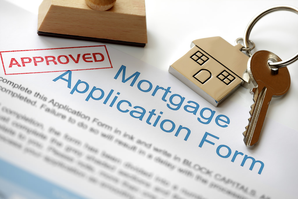 house keys with approved mortgage application
