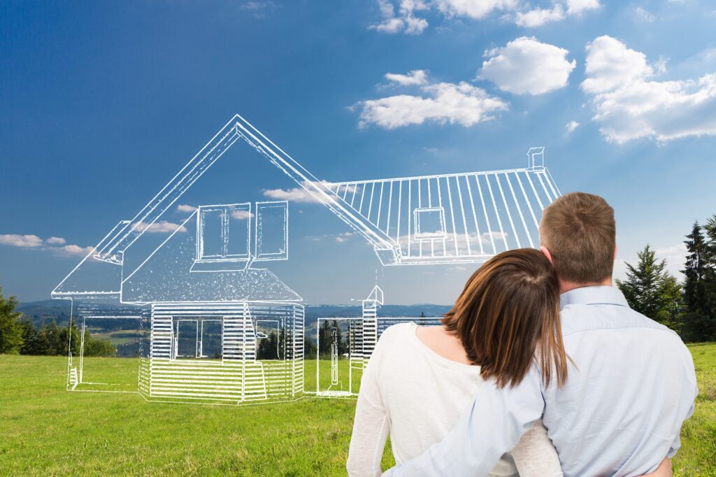man and woman staring at dream home outline