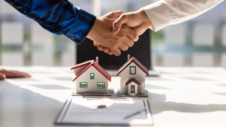 shaking hands above a housing contract