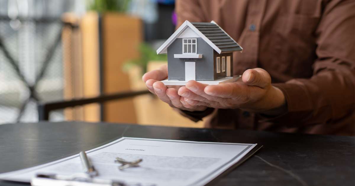 Hands holding a house