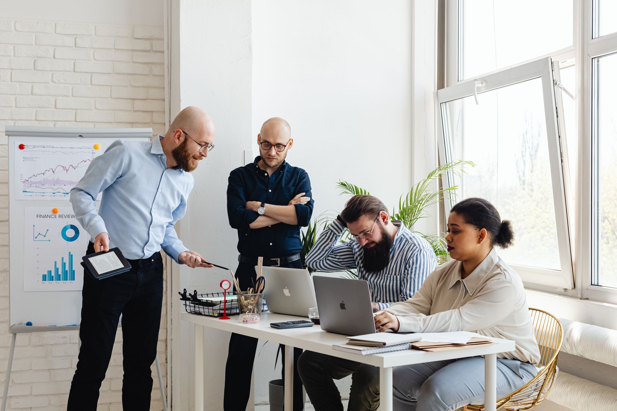Team standing around a desk in discussion