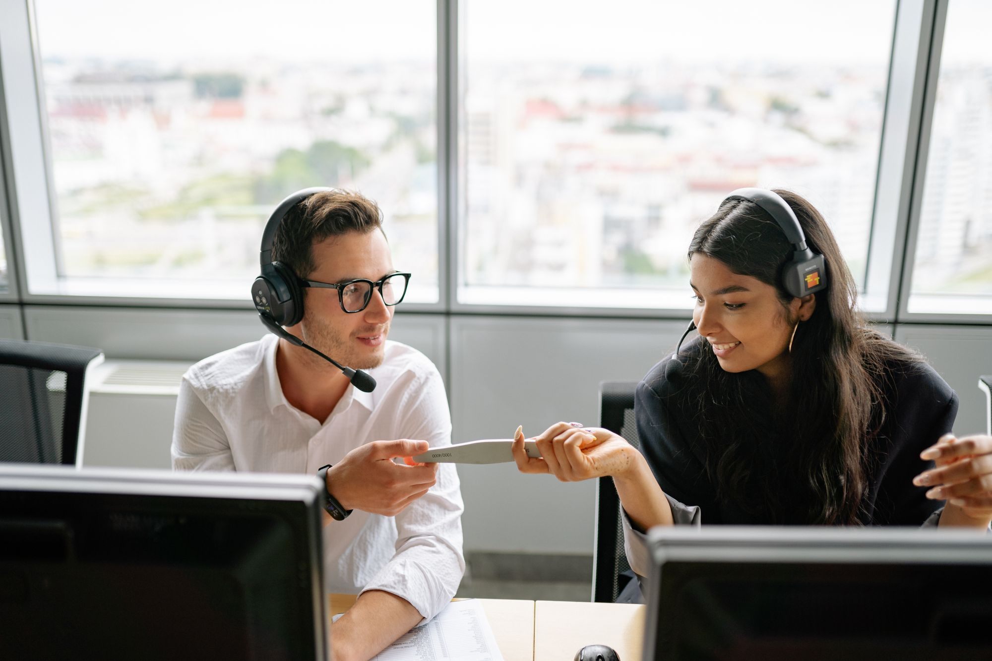 Support team wearing headsets in an office