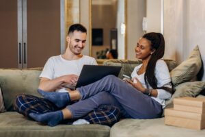 Couple on the sofa looking at a laptop