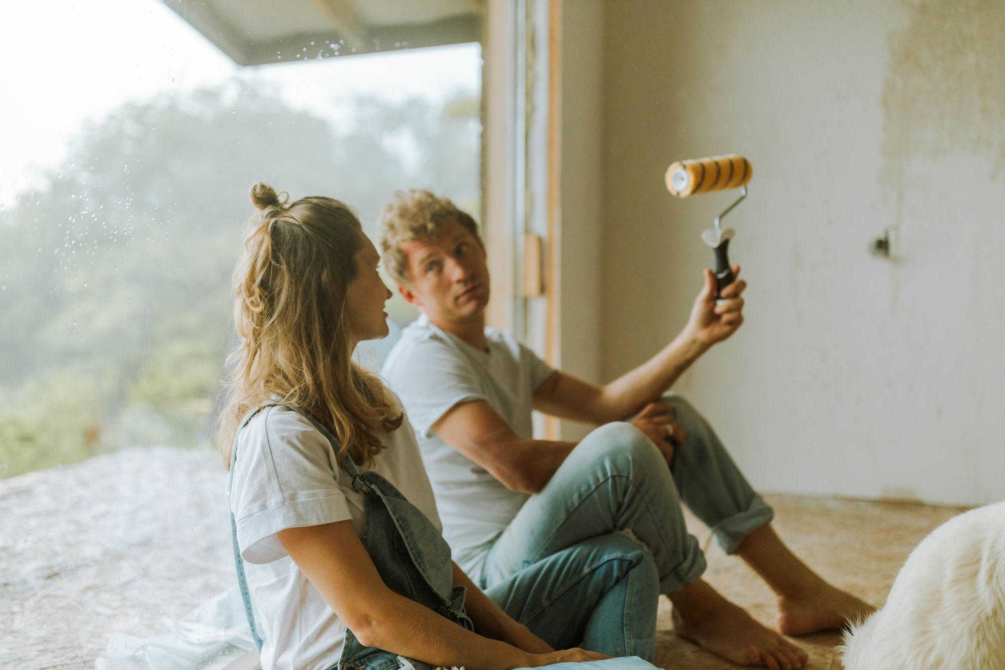 Couple painting a wall together during a home renovation