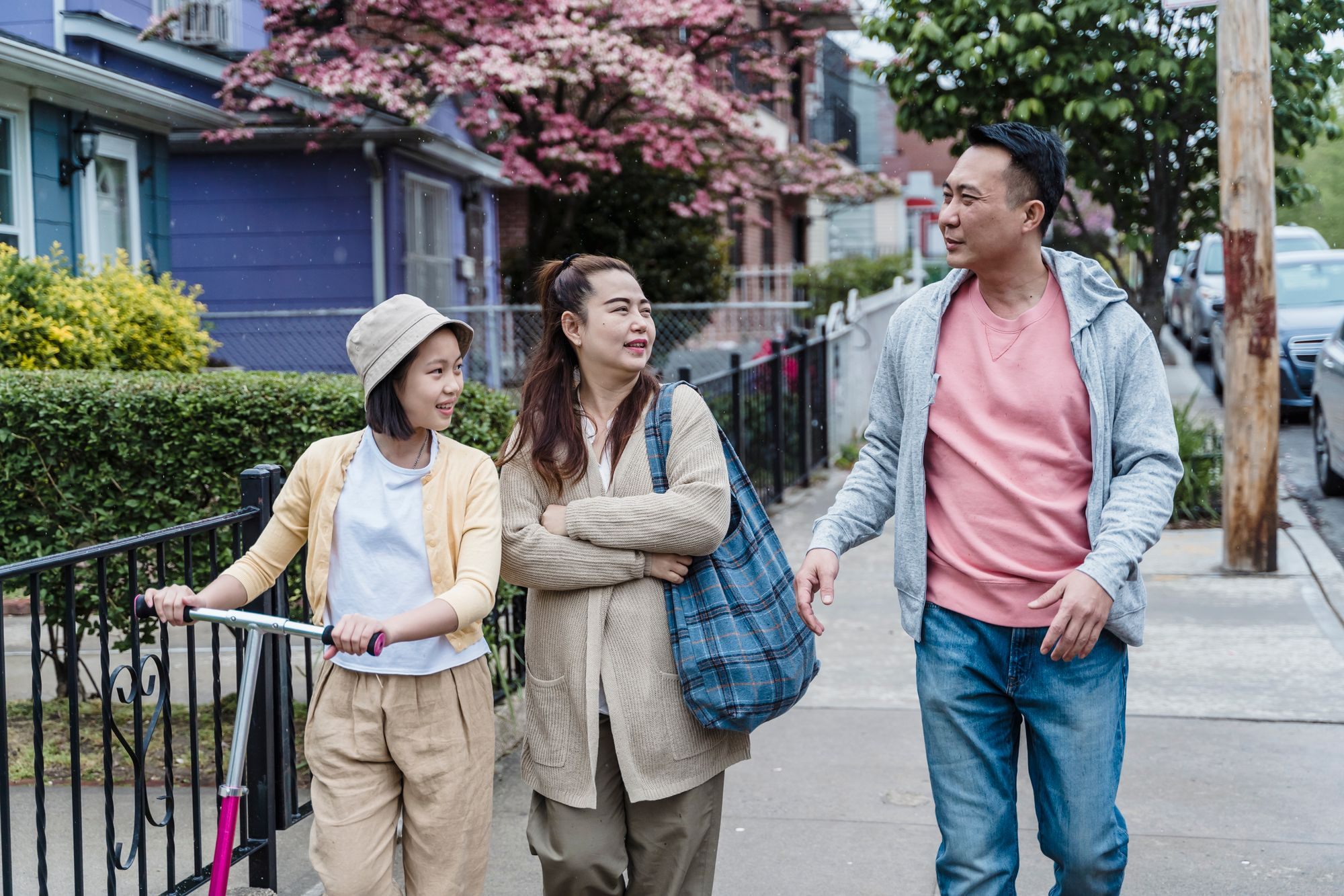 Parents walking with their daughter on a spring day
