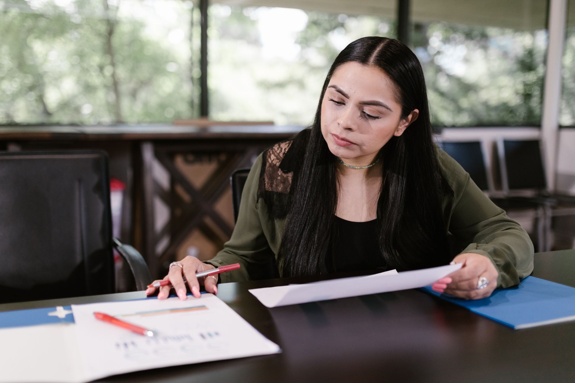 Loan officer reviewing documents at her desk