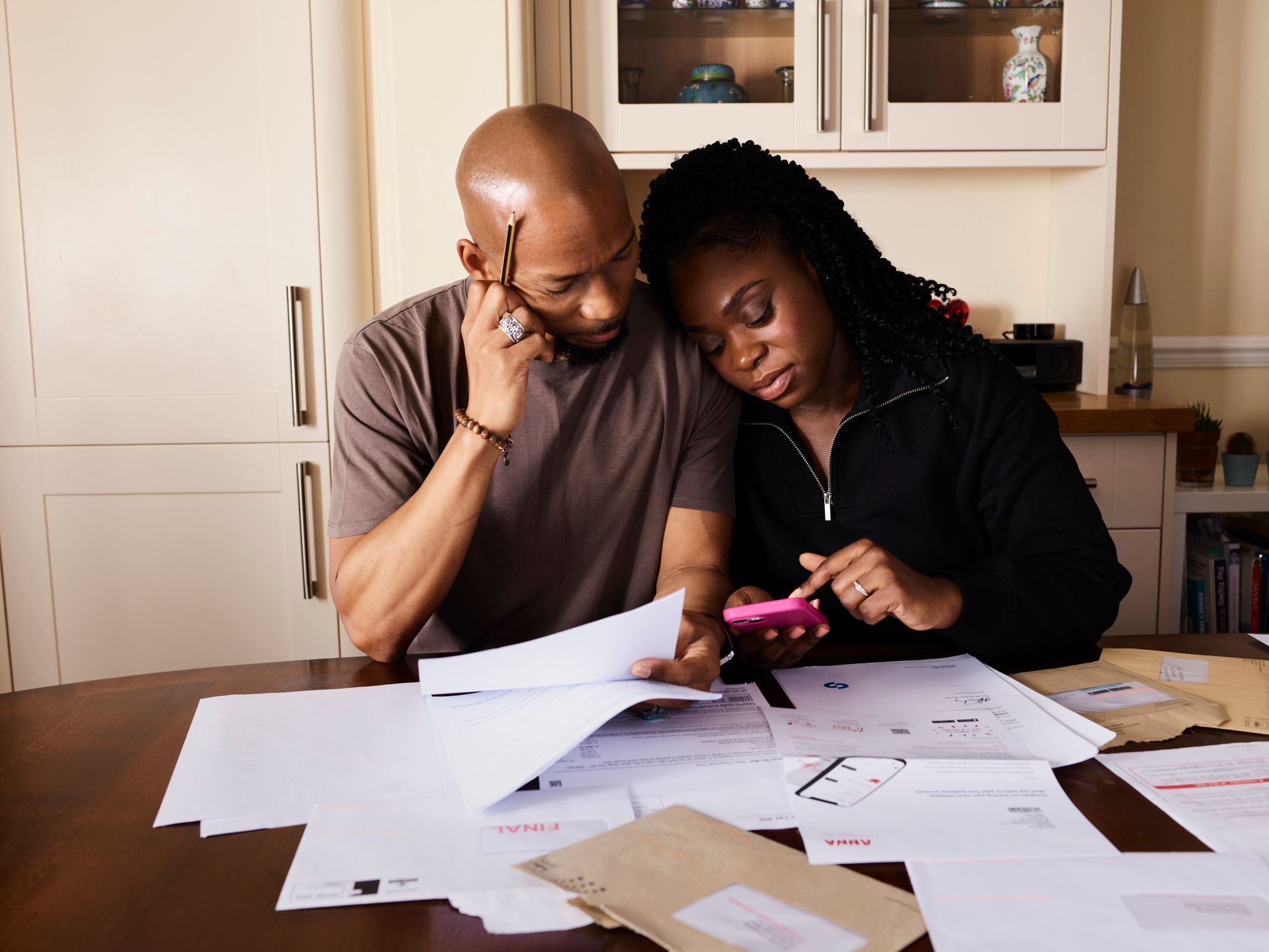 Couple going through paperwork at their dining table