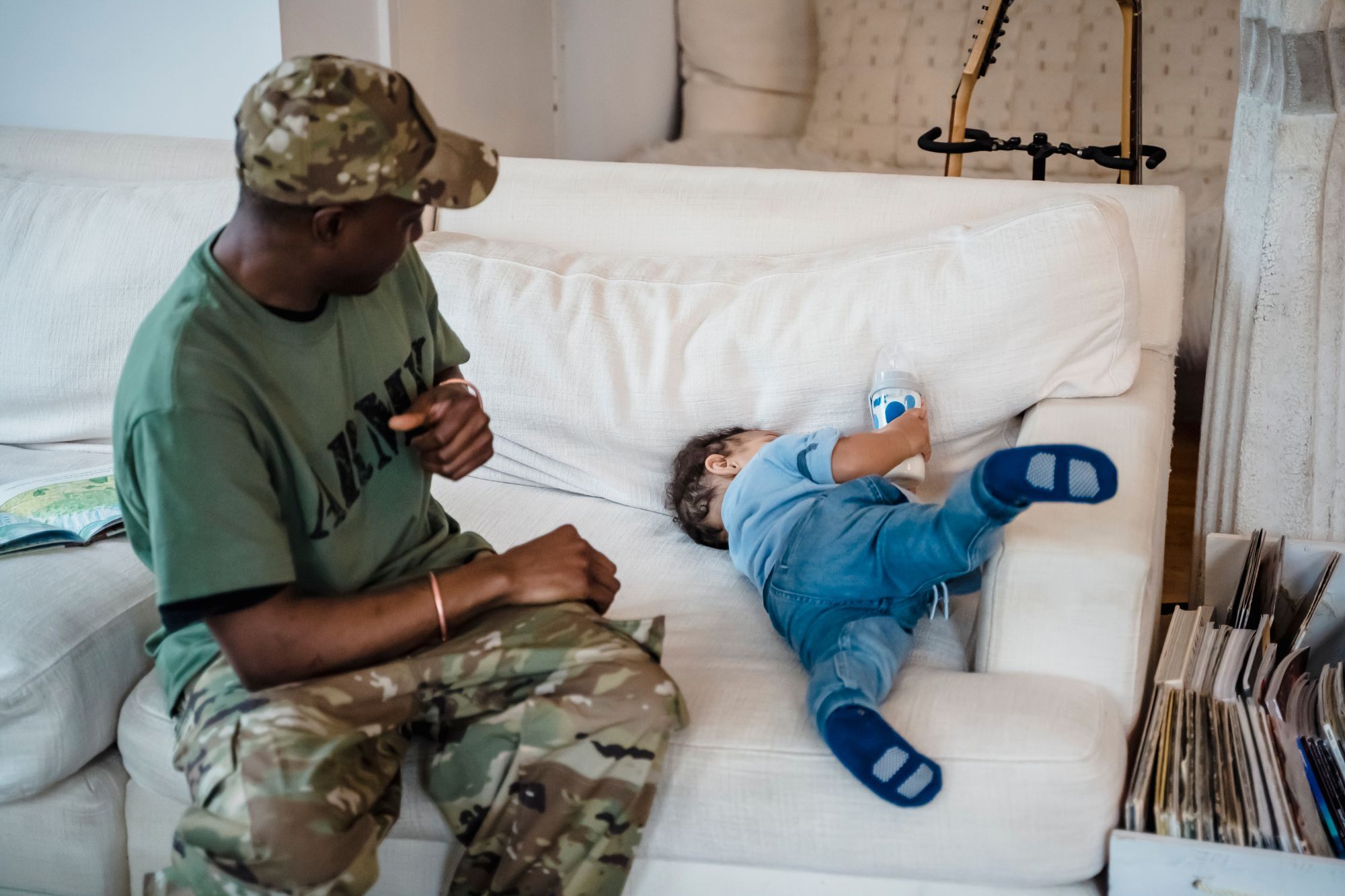 Soldier and his son spending time on the couch at home