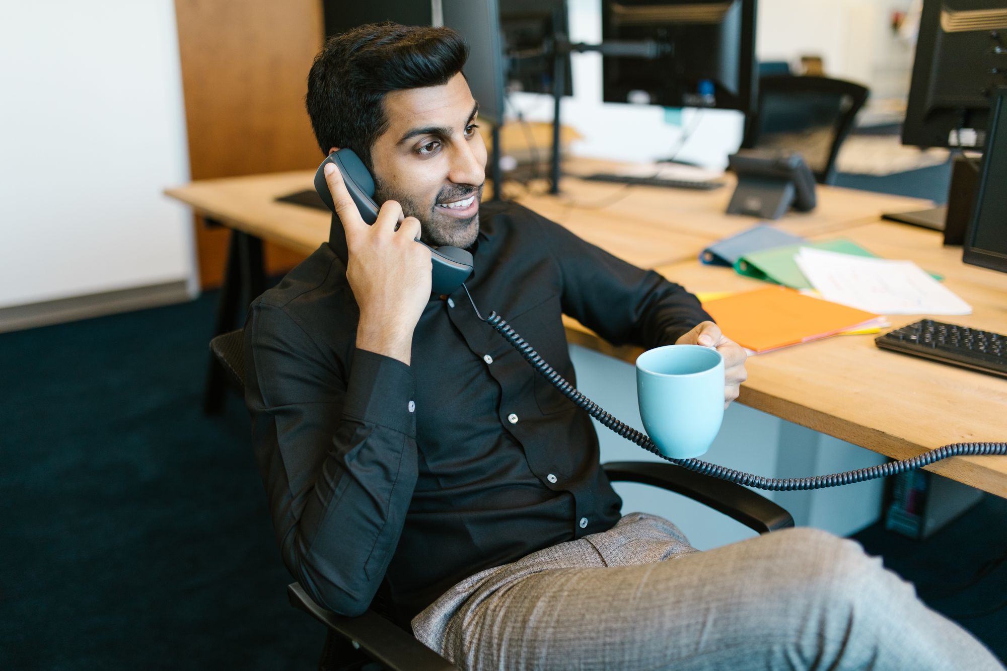Loan advisor on the phone at his desk