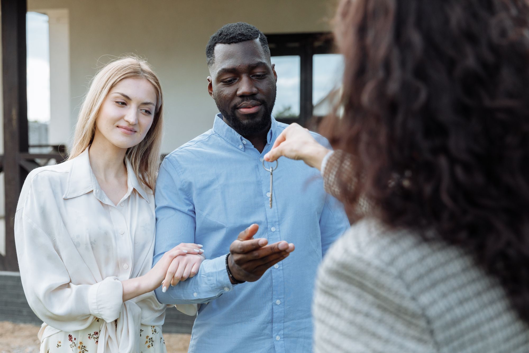 Couple receiving the keys to their new home from their agent