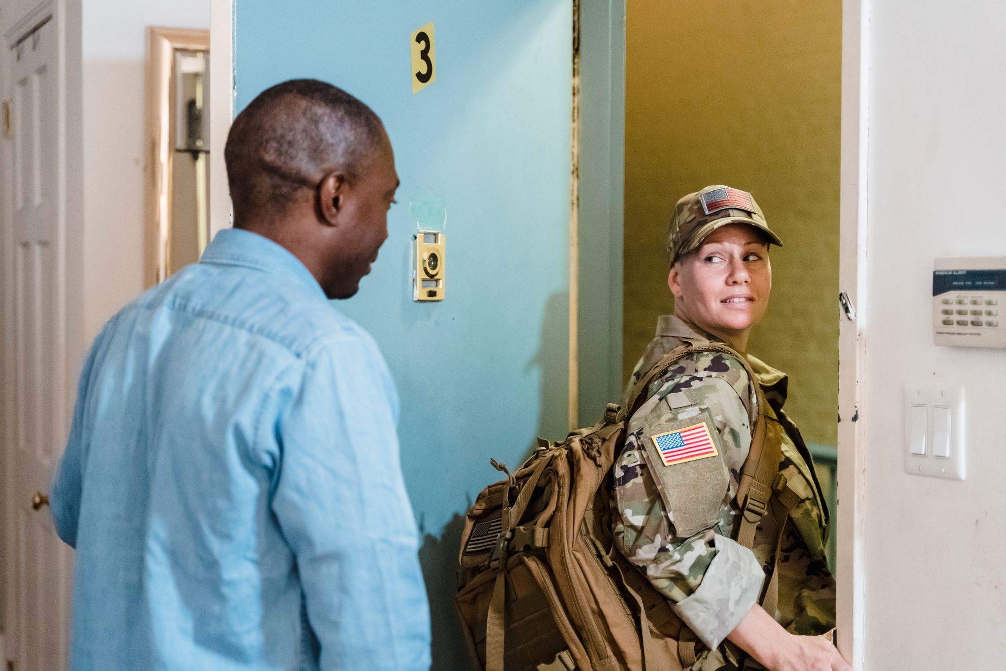 Soldier returning home is greeted by her partner at the door
