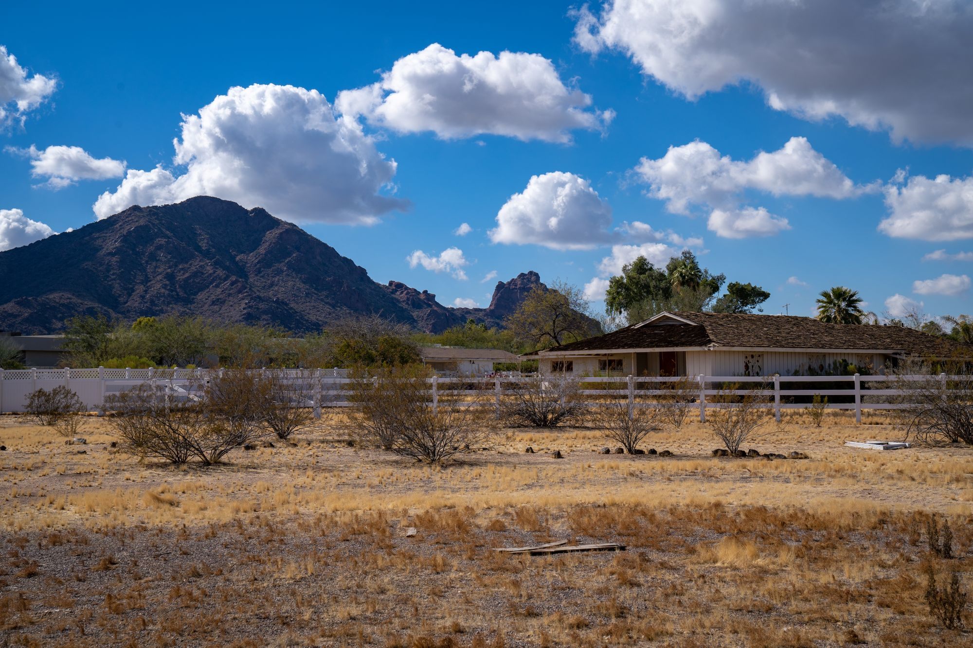 Arizona home beneath a desert mountain under a blue sky