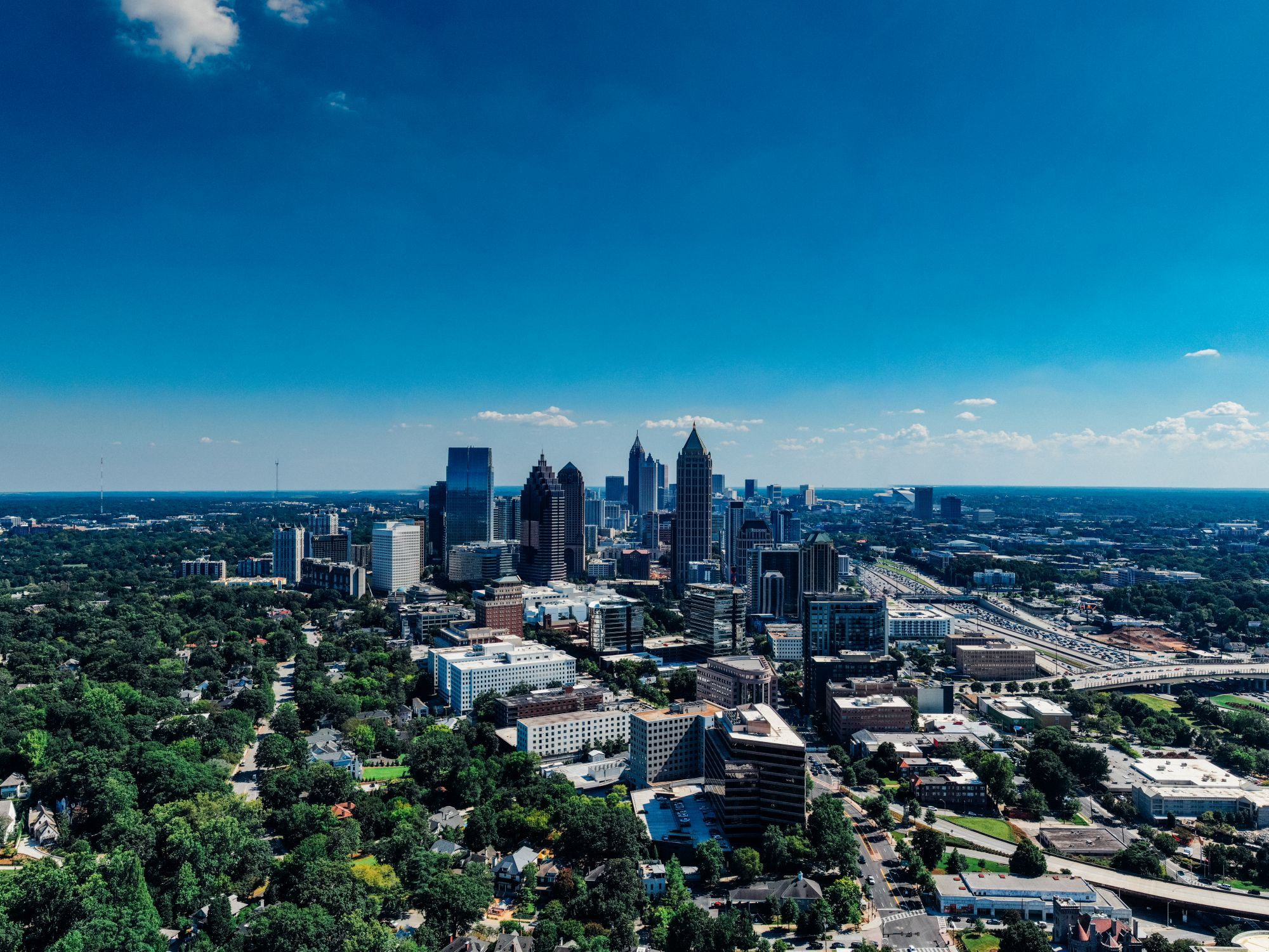 Aerial view of the Atlanta skyline above the tree canopy