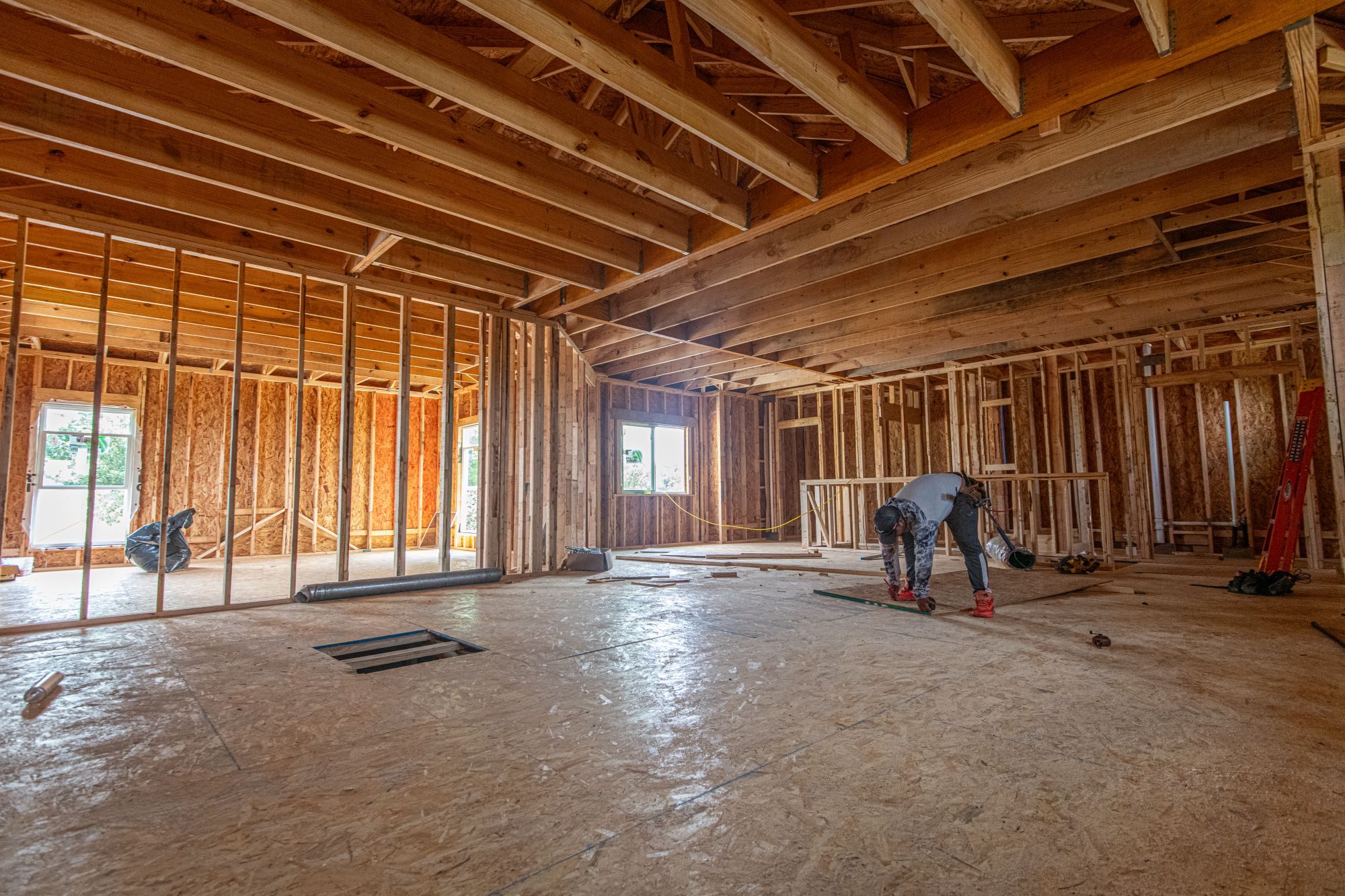 Interior of a home addition under construction with fresh framing