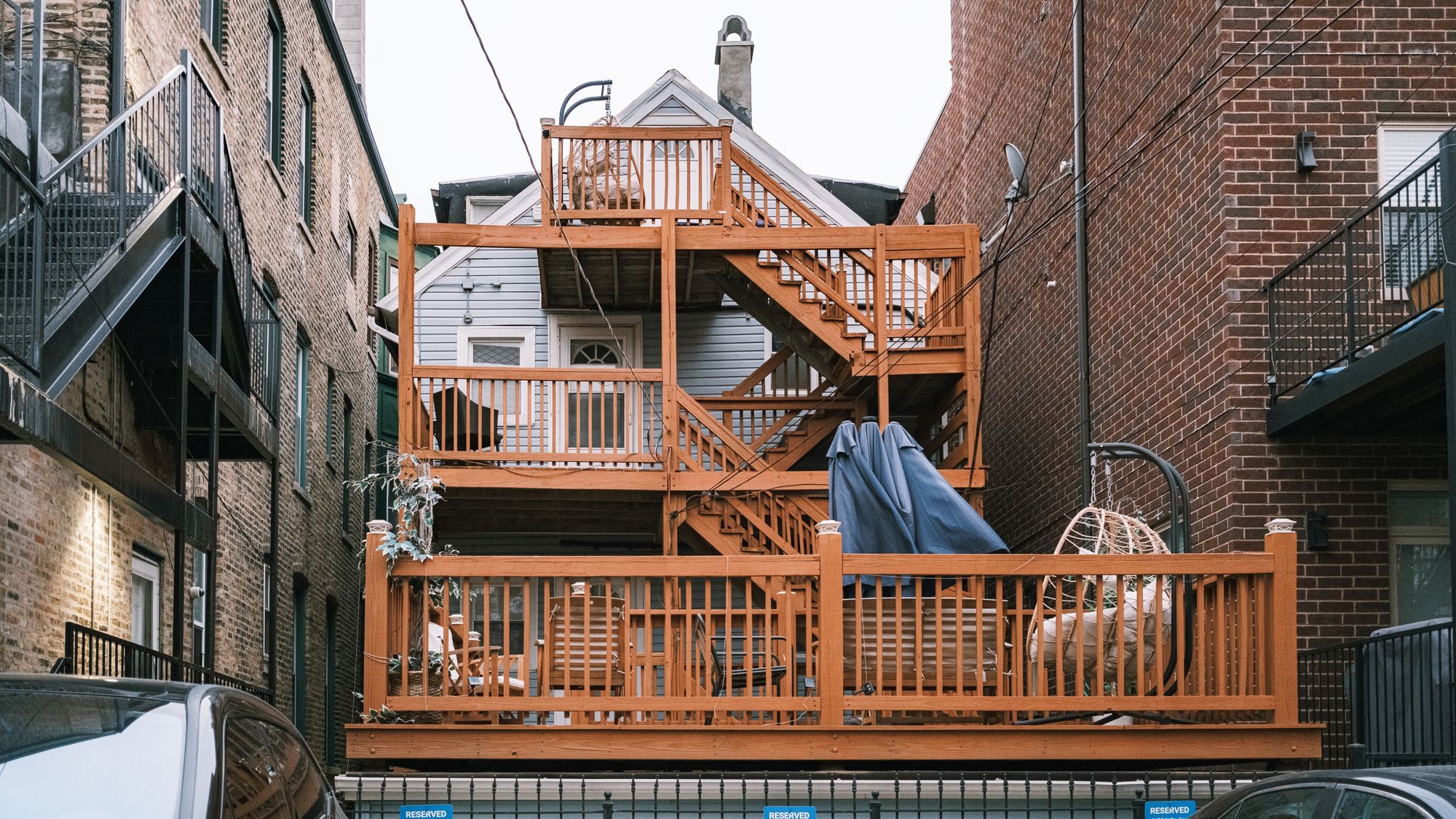 Multi-level wooden deck built onto the back of a home