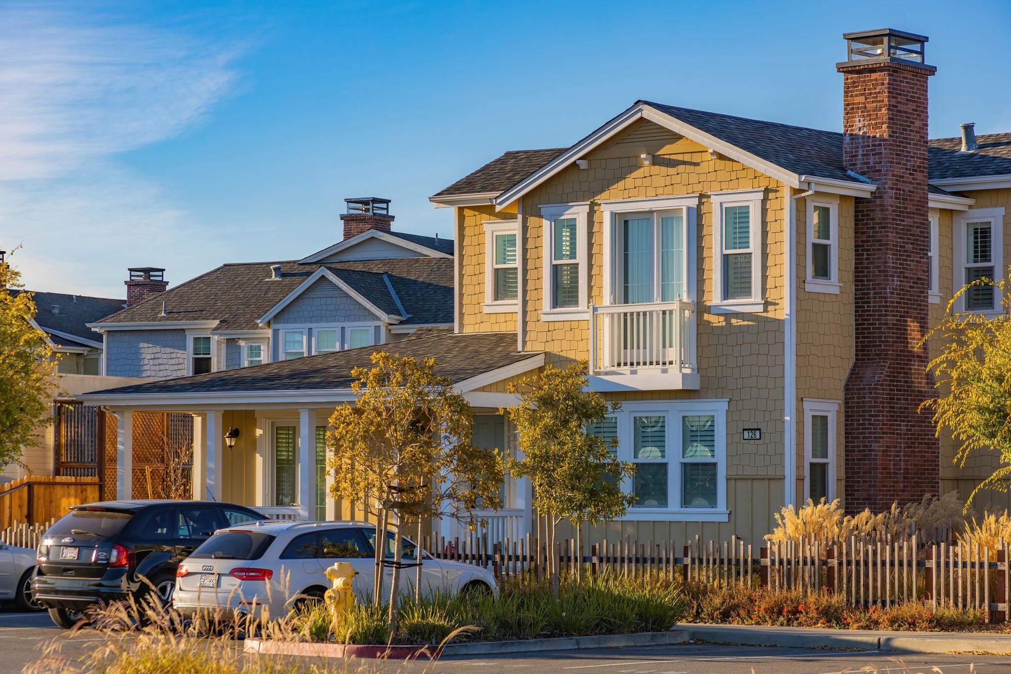 Two-story home with a tidy front yard on a sunny street