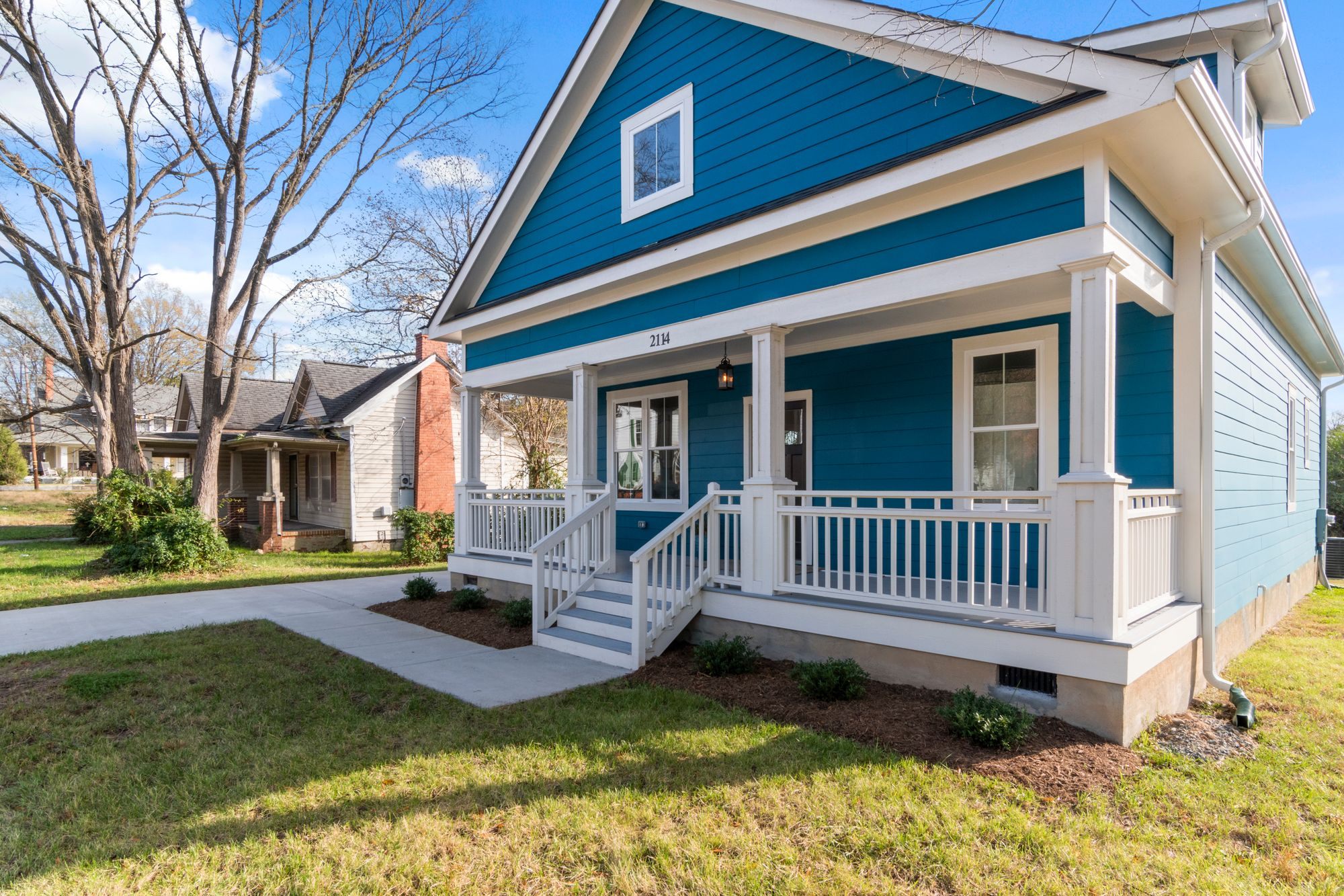 Blue craftsman home with a covered front porch