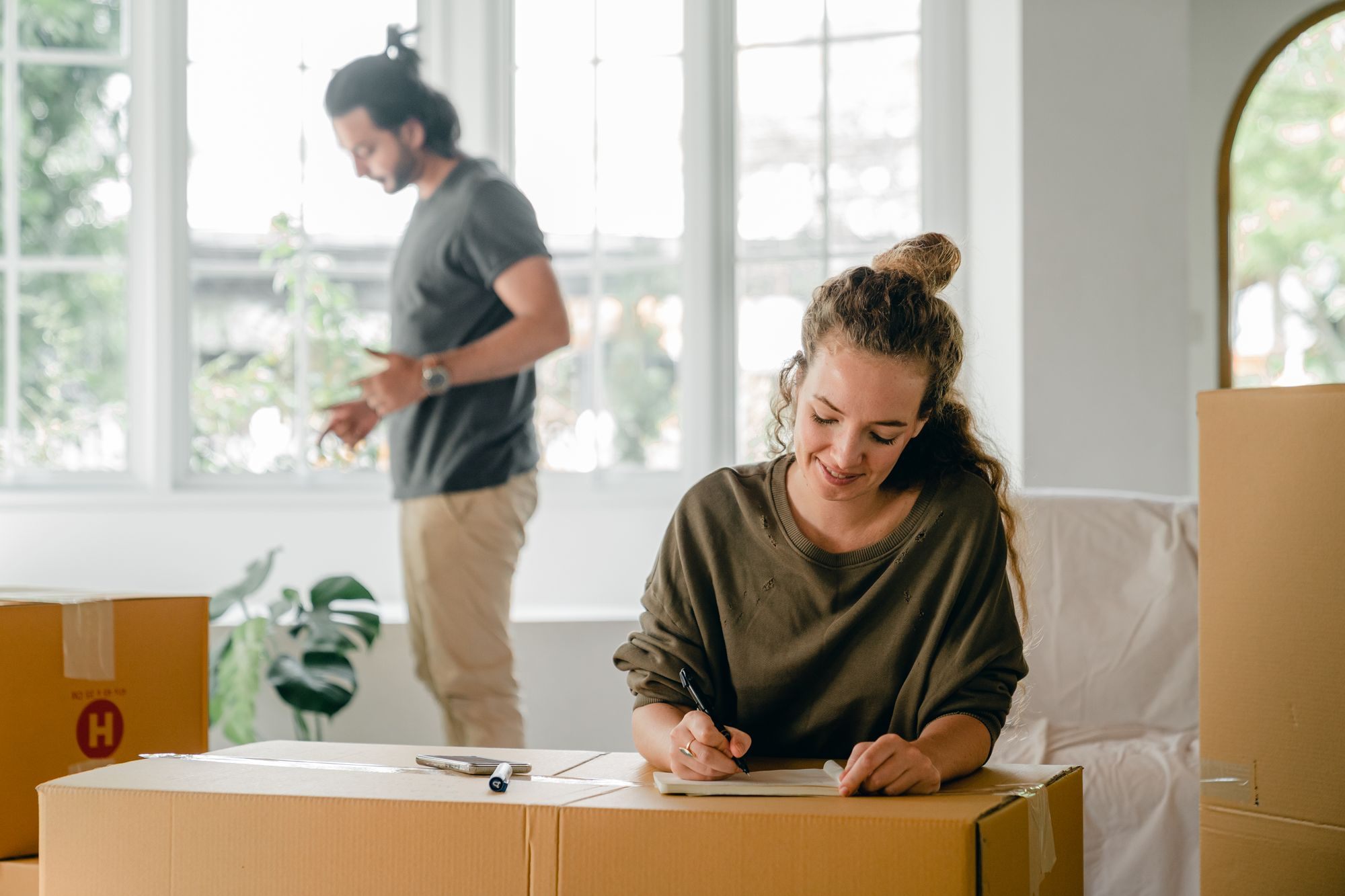 Couple unpacking boxes in their new home