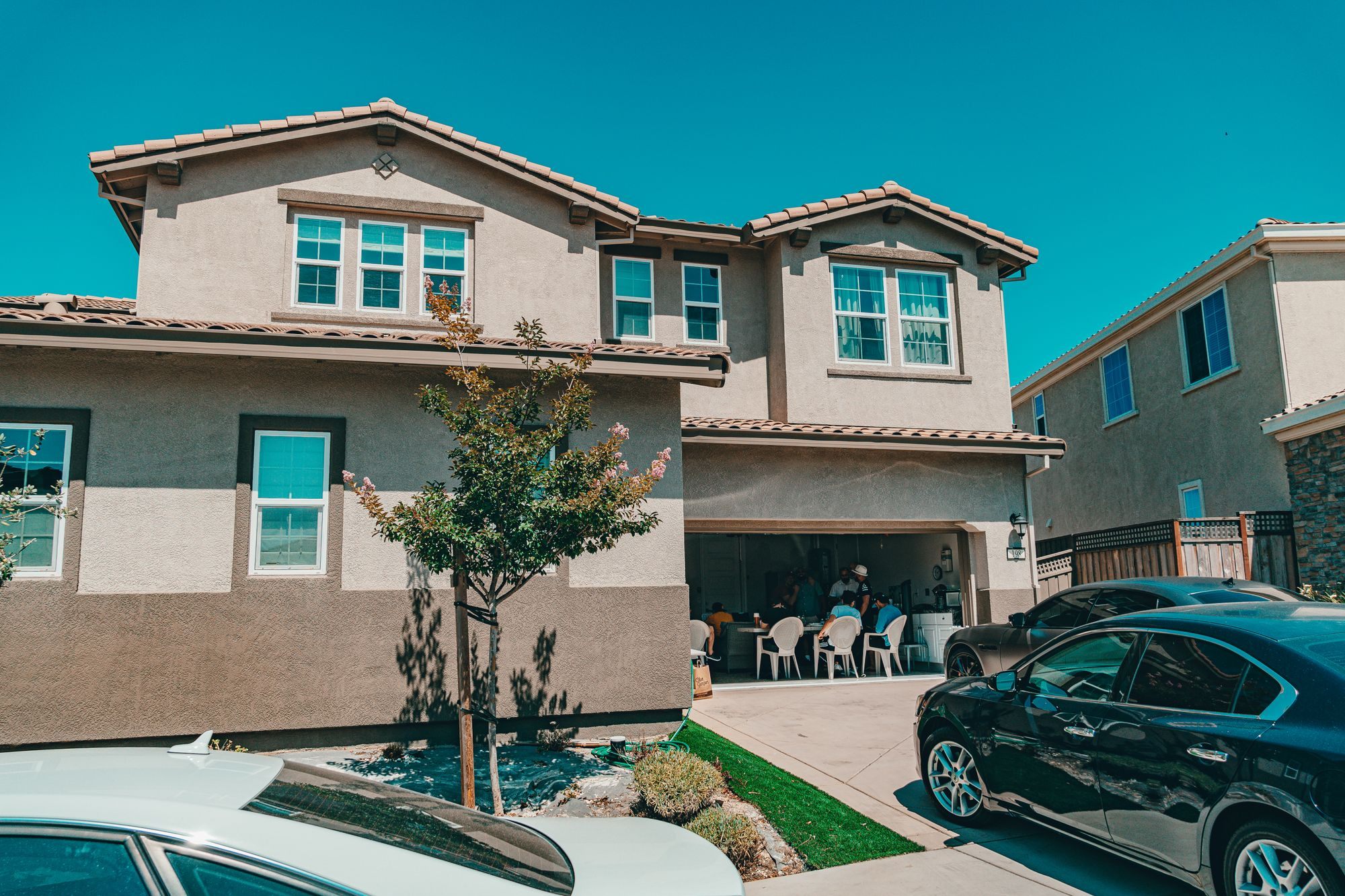 Two-story stucco homes on a sunny residential street