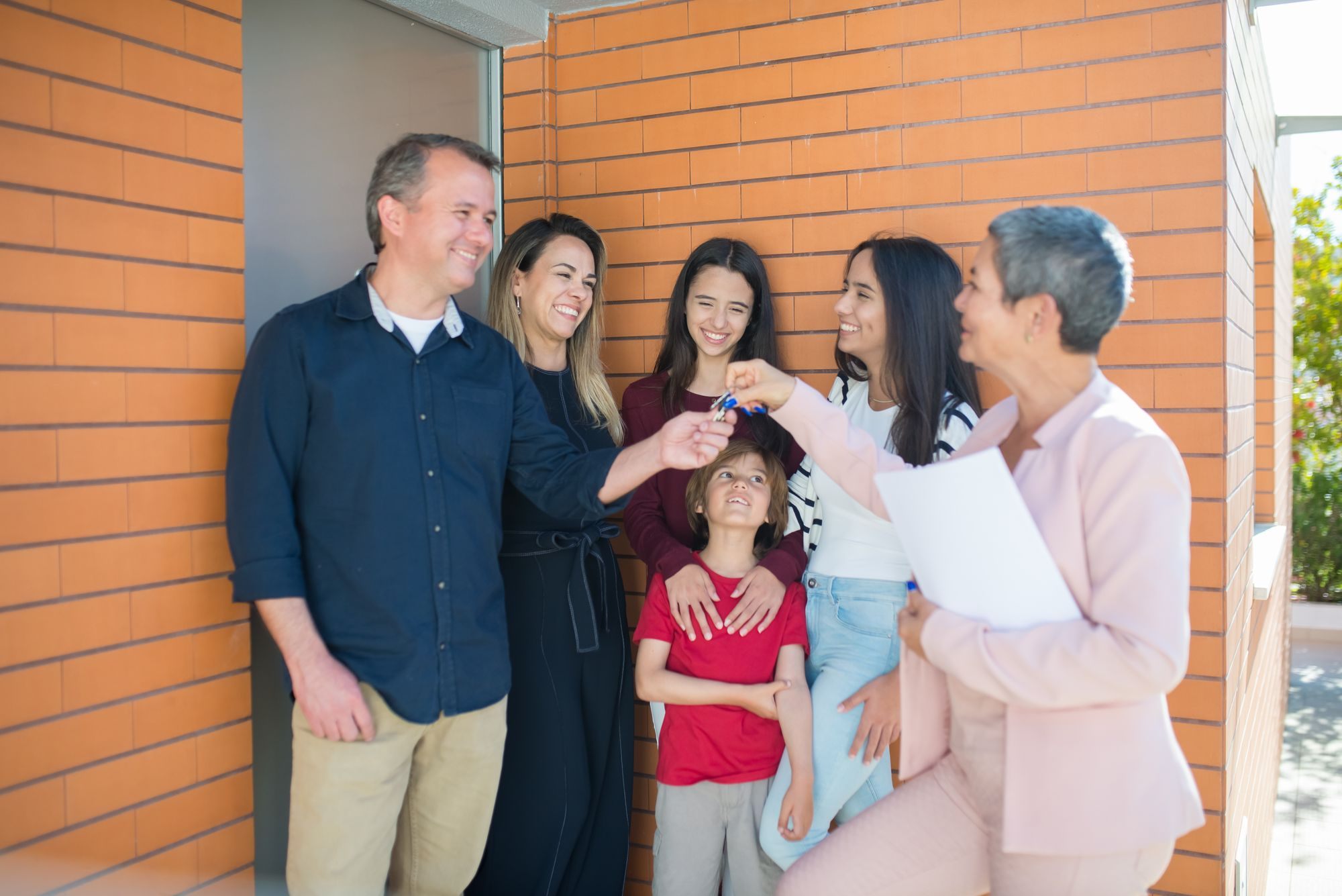 Family outside their new brick home