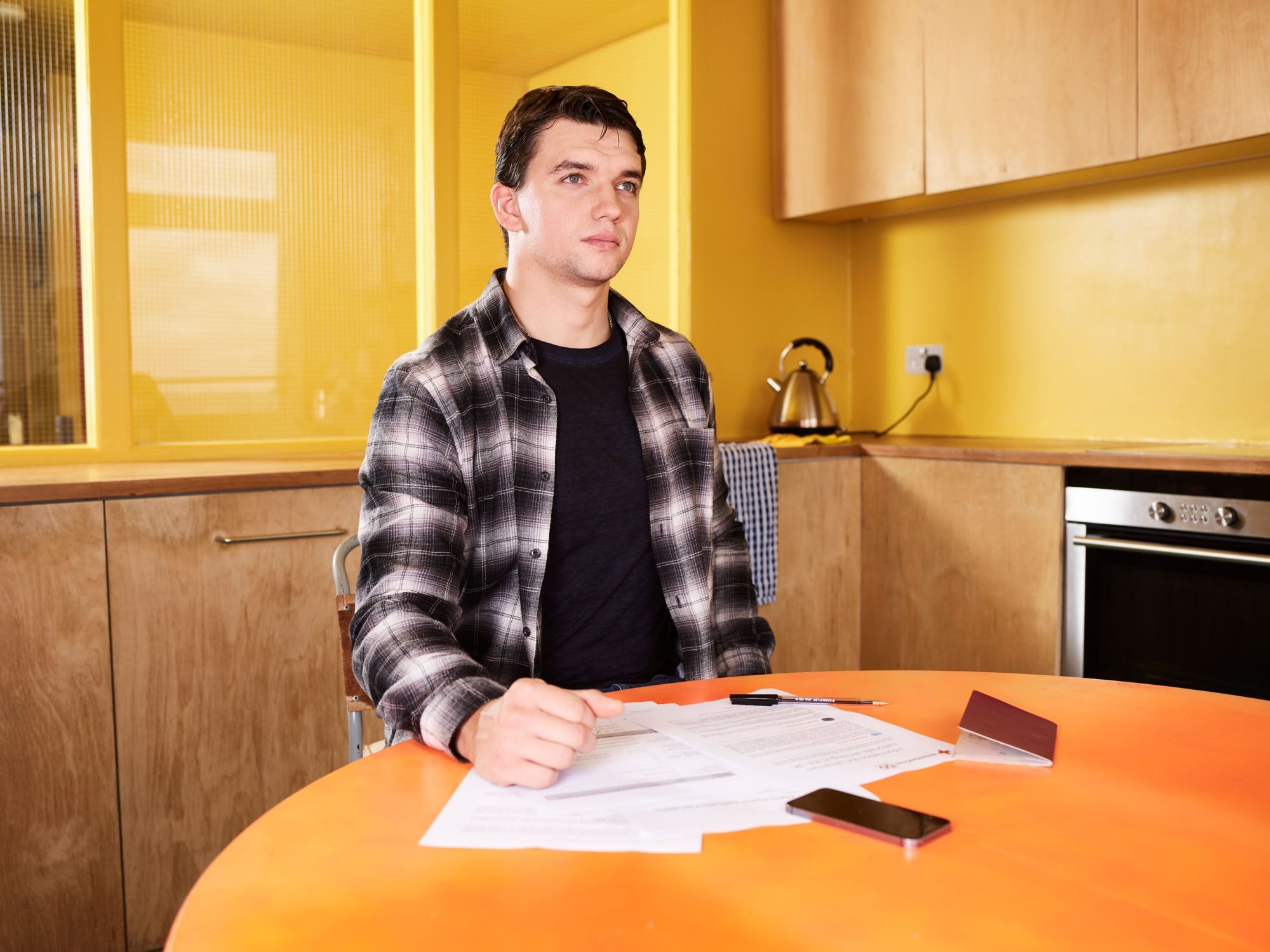 Homeowner reviewing paperwork at the kitchen table