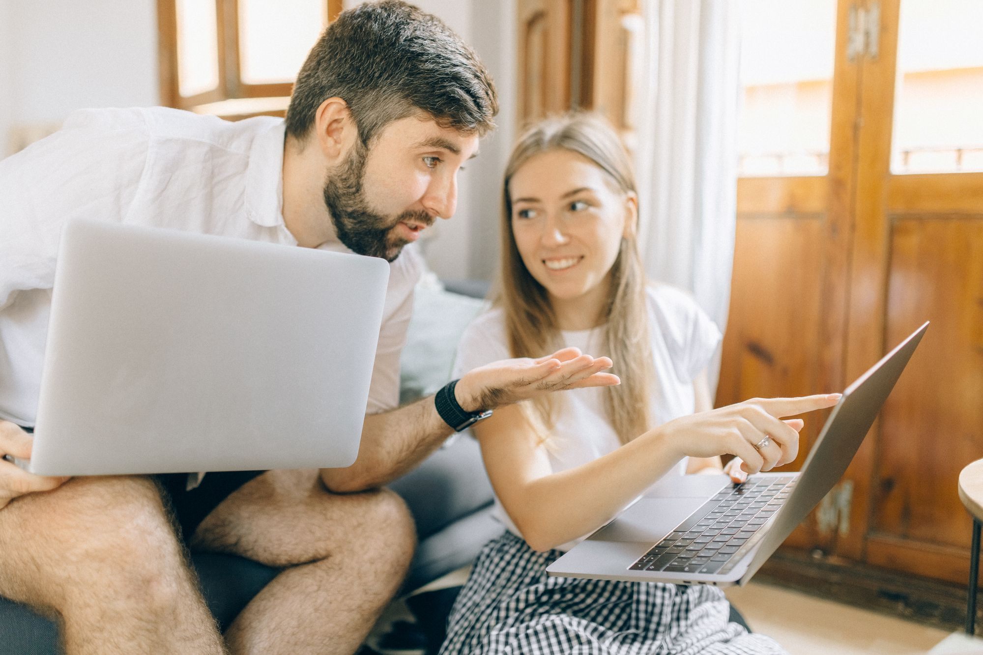 Couple going over their finances on a laptop at home