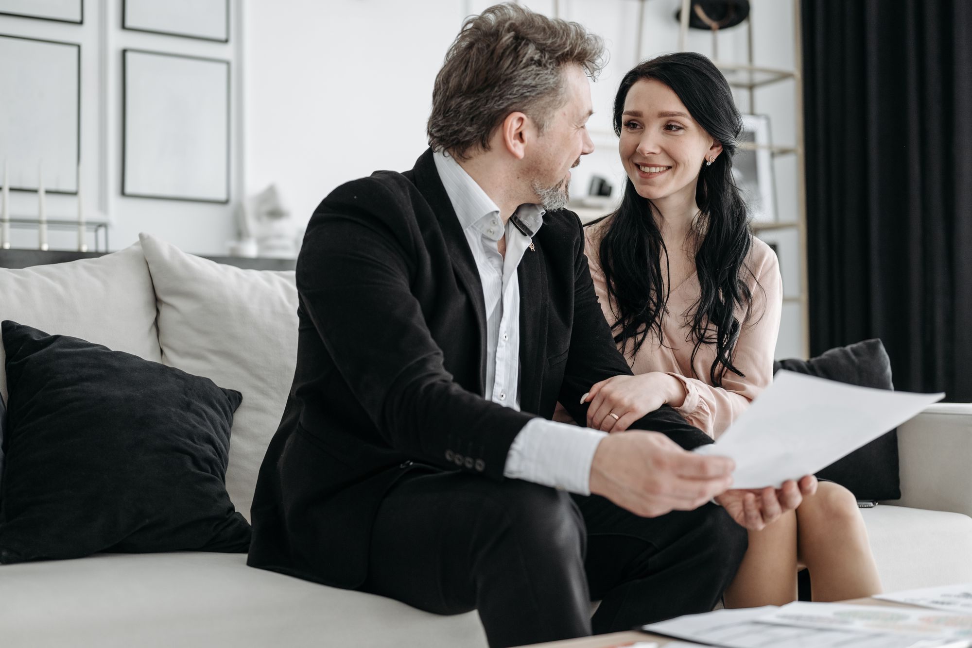 Couple on a sofa reviewing paperwork together
